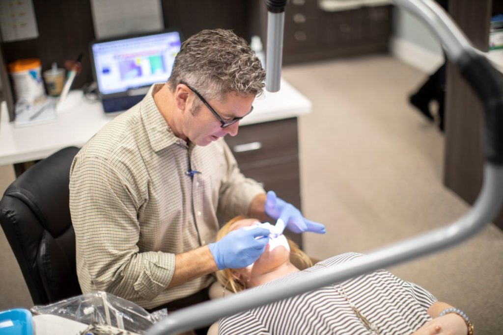 Glass Dr. Glass working on a patient Glass Orthodontics